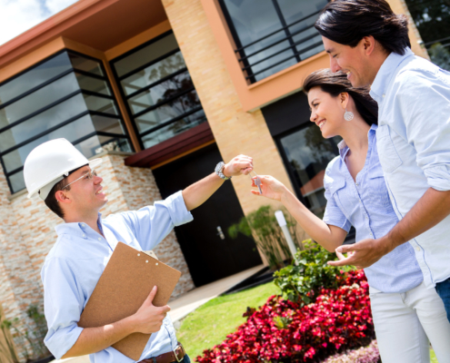 architect handling keys to a couple architect handling keys to a couple